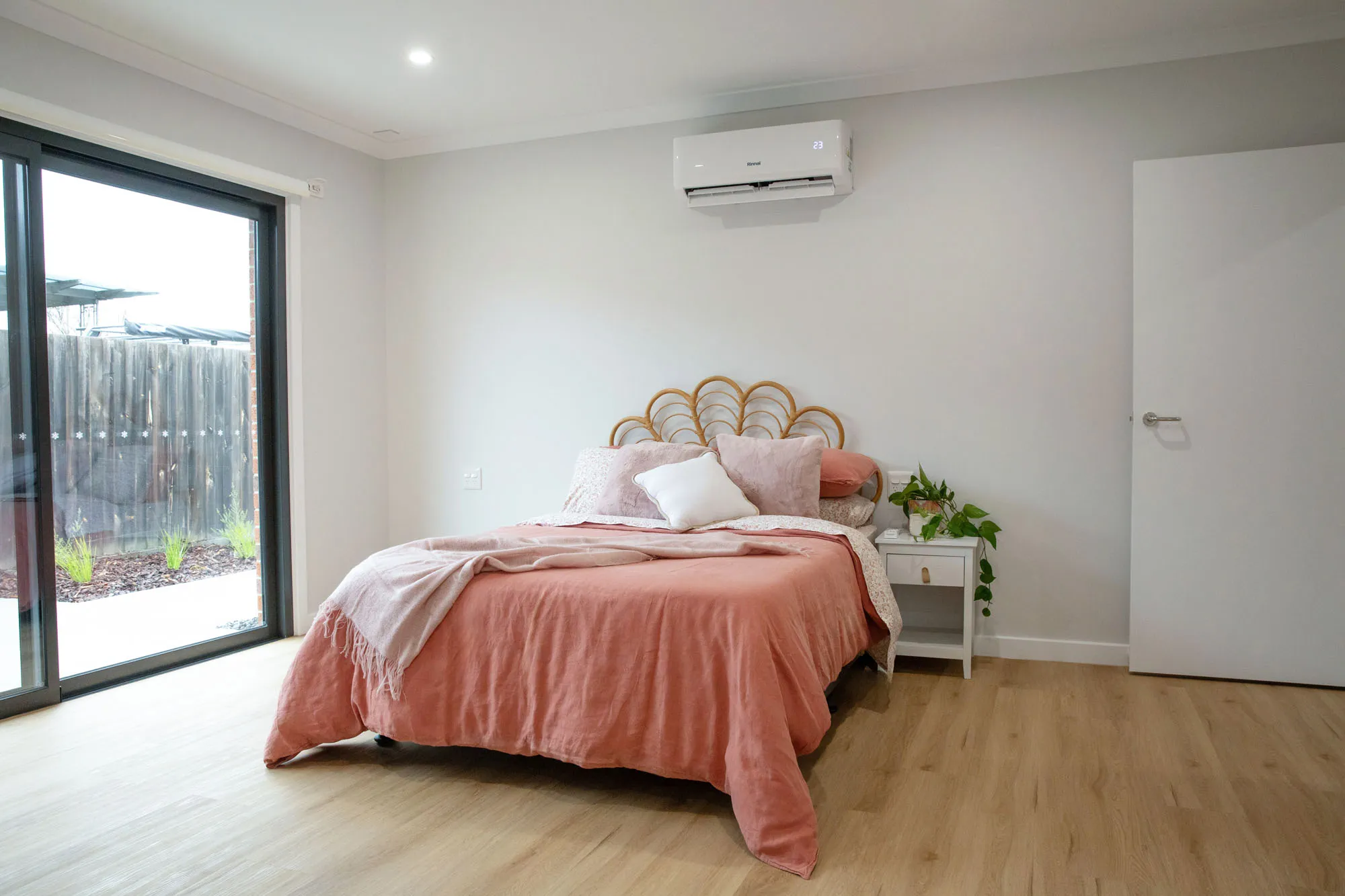 A bedroom with pink sheets