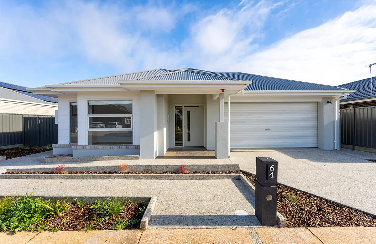 The front of a large house with a garage and wheelchair ramp