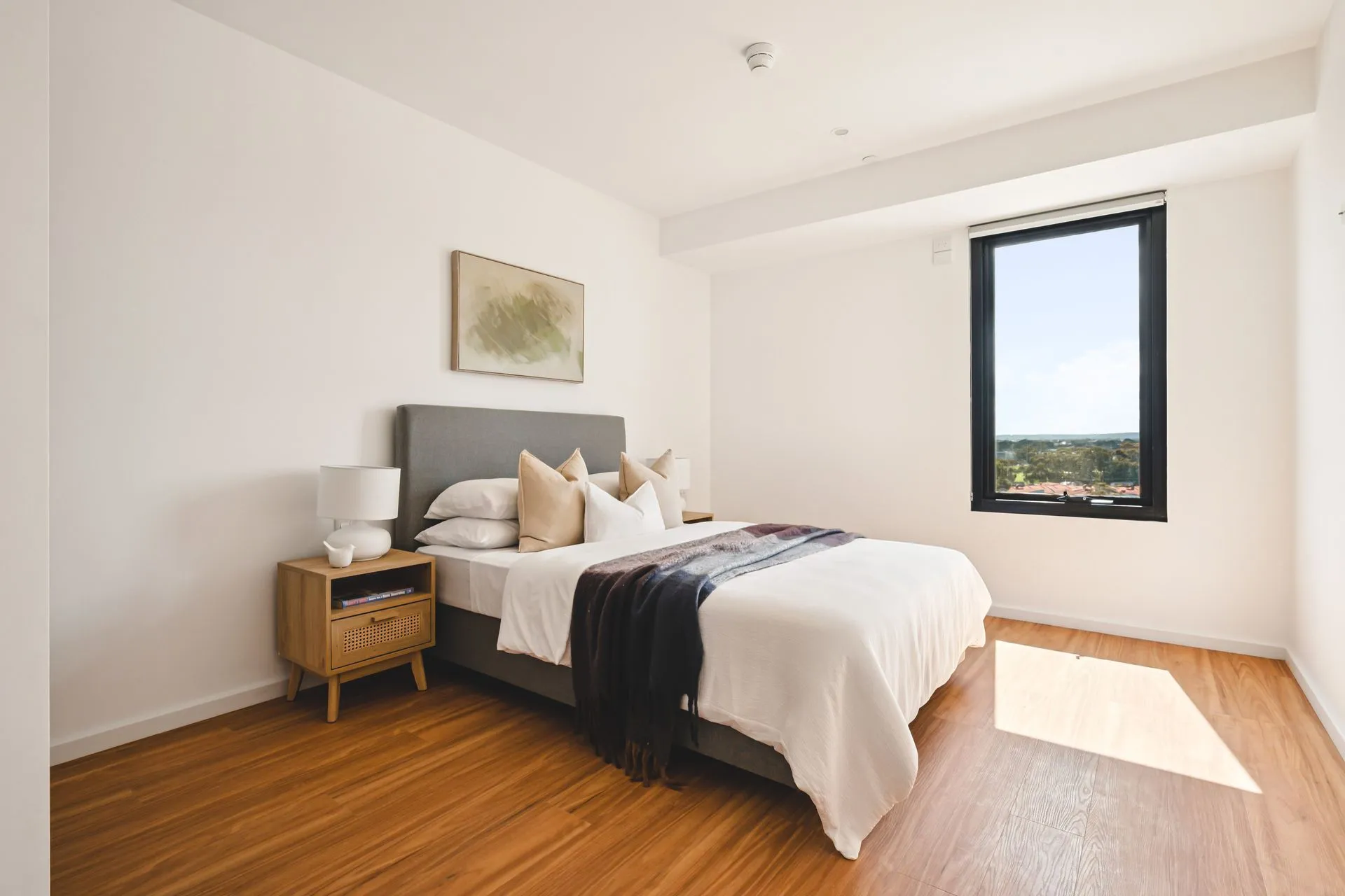 A bedroom with wood floors