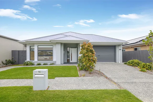 The front of a house with a nice lawn and a garage