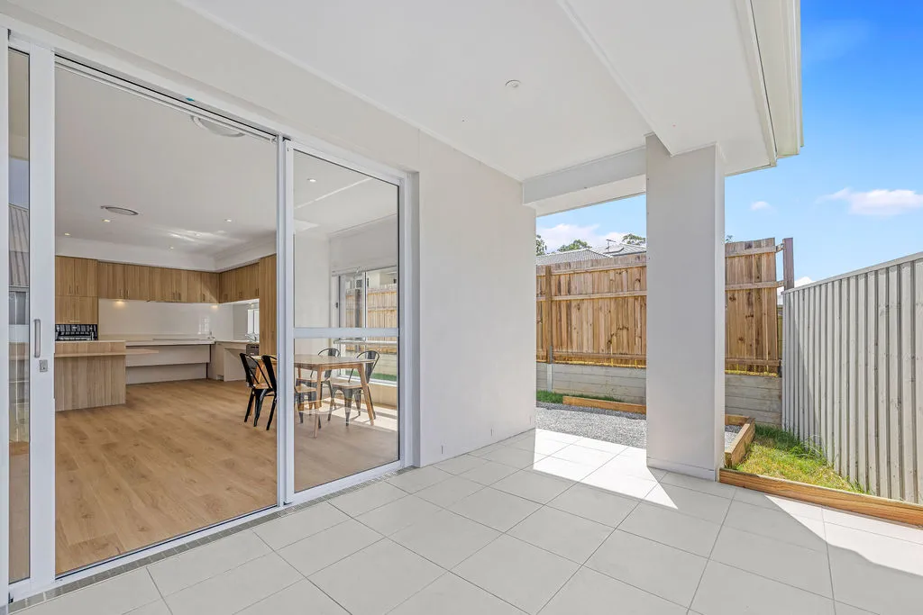 A tiled back deck leading into a dining area