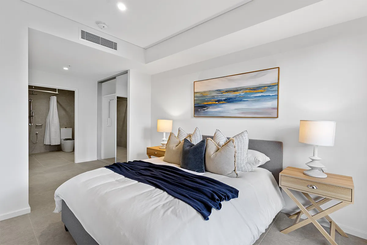 A bedroom with a large bed and an ensuite