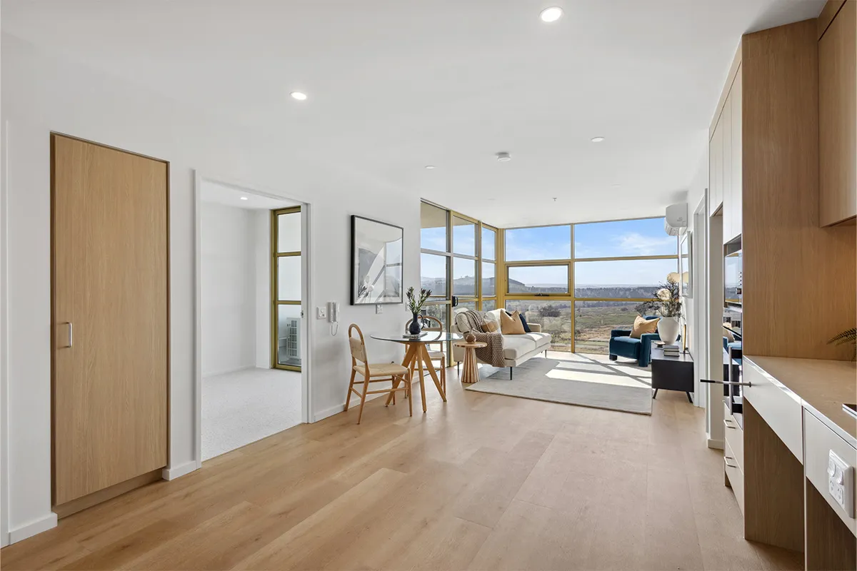 An apartment loungeroom with a view of parkland