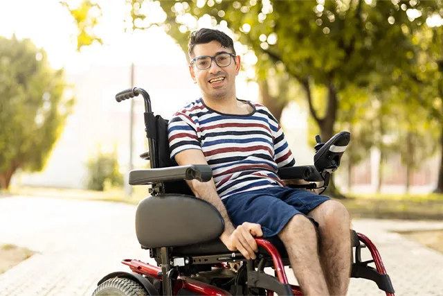 A man in a wheelchair smiling
