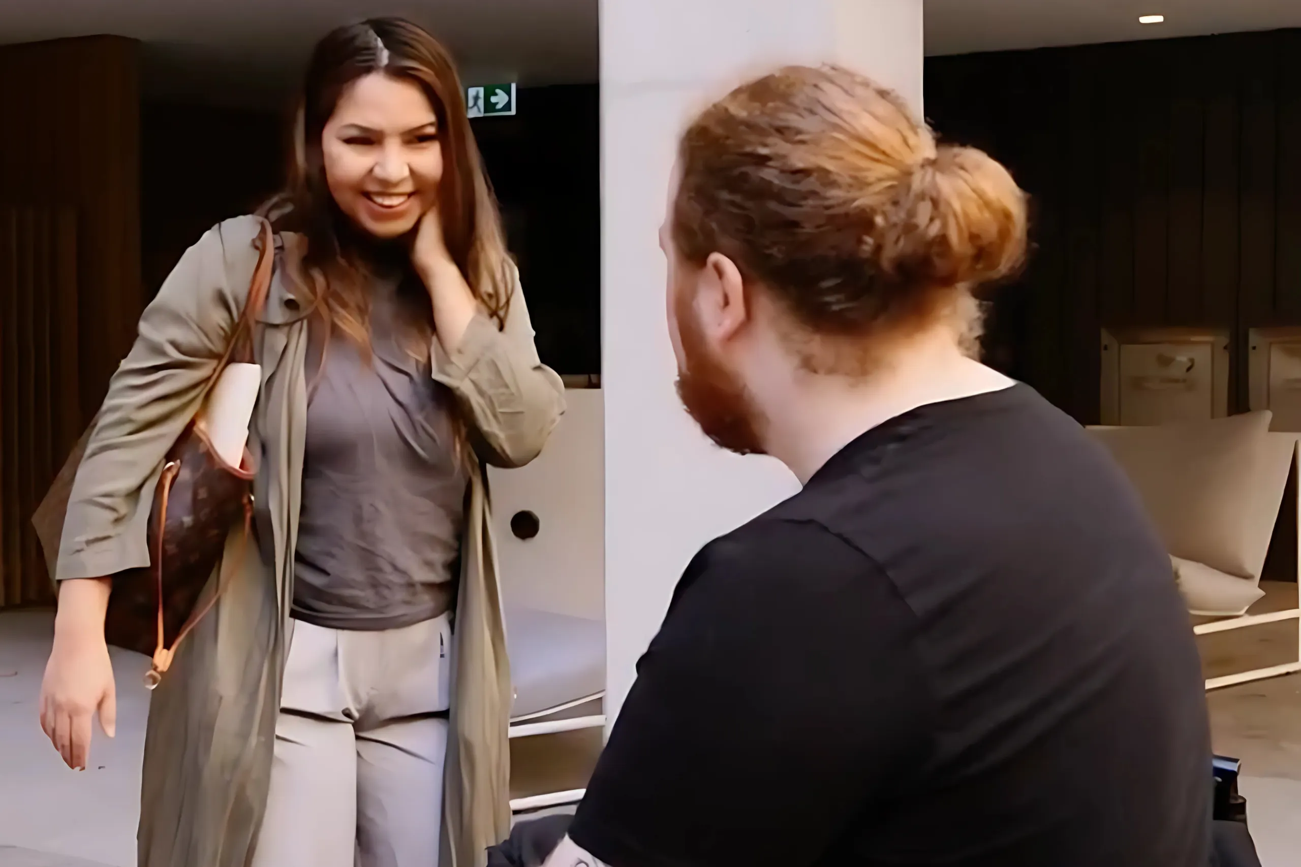 Two people smiling while talking to each other
